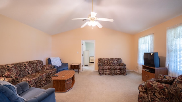 living room with ceiling fan, vaulted ceiling, and light colored carpet