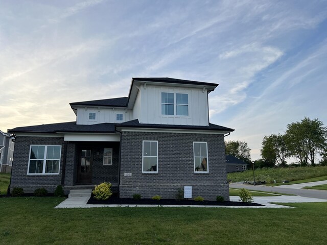 rear view of house with a lawn