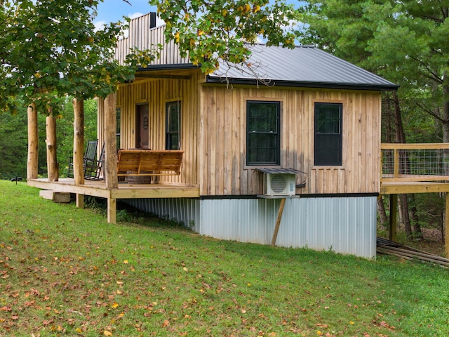 rear view of property with a yard