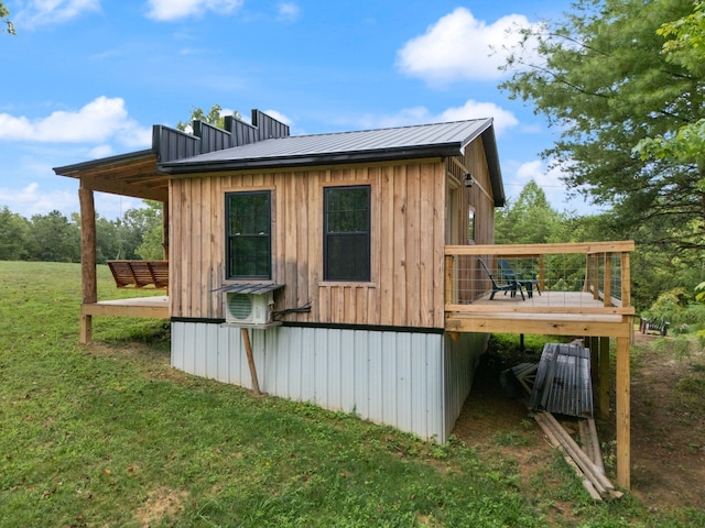 view of outbuilding featuring a lawn