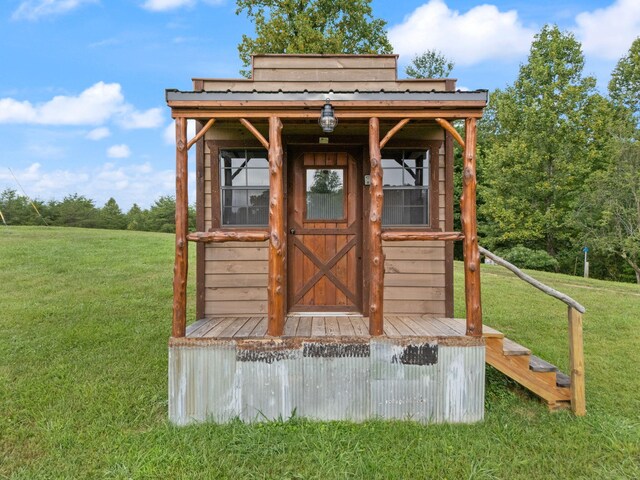 view of outbuilding featuring a lawn