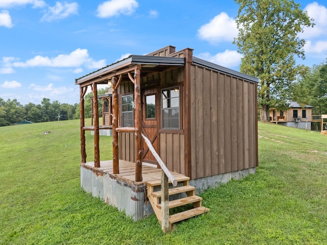 view of outbuilding featuring a lawn