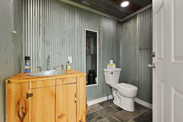 bathroom with tile patterned flooring, vanity, and toilet