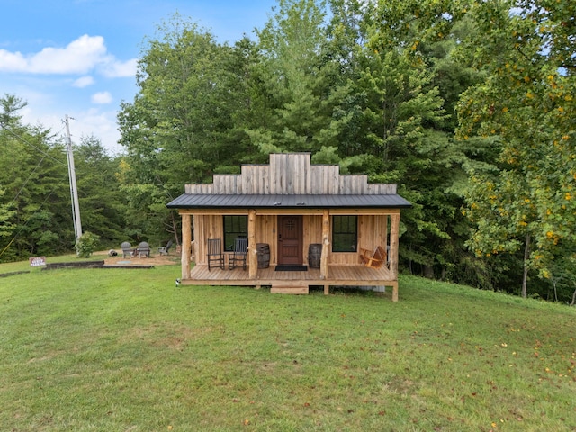 back of property featuring a lawn