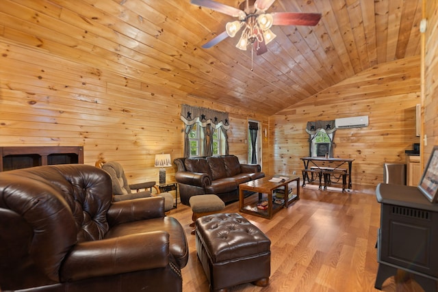 living room with lofted ceiling, a wall mounted air conditioner, ceiling fan, wooden ceiling, and hardwood / wood-style flooring