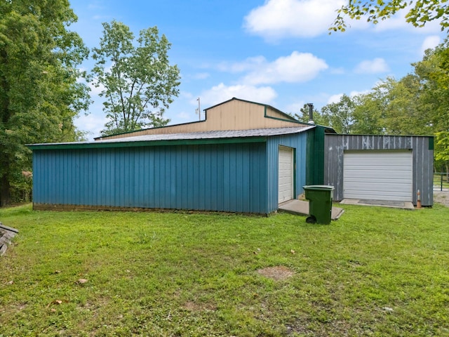 view of outdoor structure with a lawn and a garage