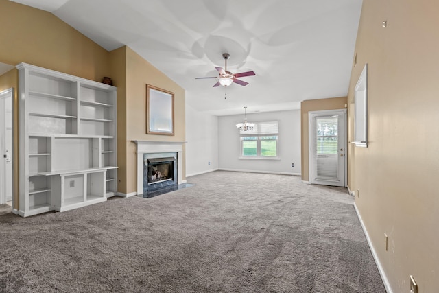 unfurnished living room with ceiling fan with notable chandelier, carpet flooring, a high end fireplace, and lofted ceiling