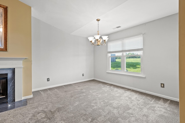 unfurnished living room featuring a fireplace, a chandelier, and carpet flooring