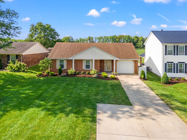 view of front of property with a garage and a front lawn