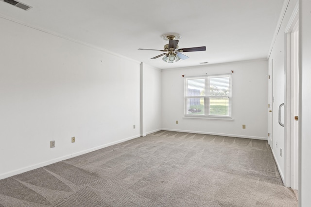 unfurnished room with carpet floors, ceiling fan, and crown molding