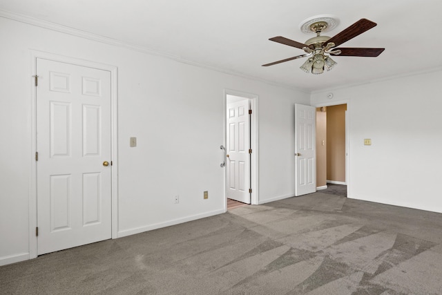 spare room featuring ceiling fan, carpet flooring, and ornamental molding