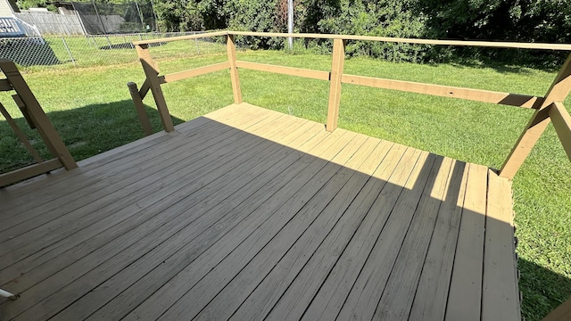 deck with a trampoline and a lawn