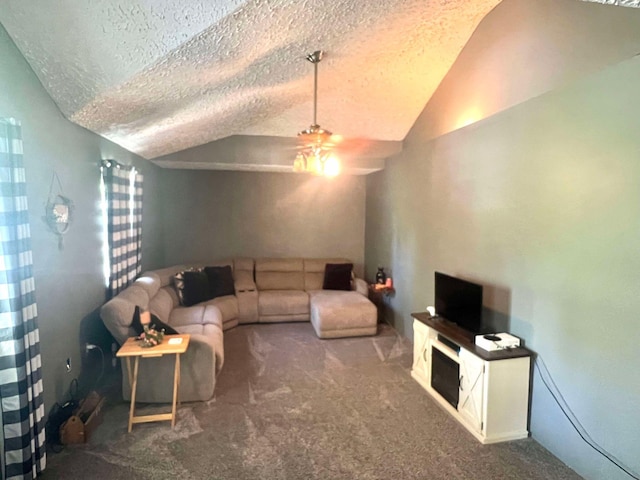 living area with ceiling fan, a textured ceiling, carpet flooring, and lofted ceiling