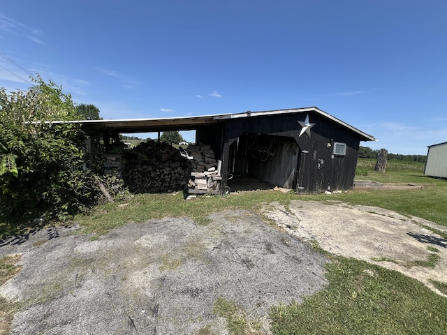 back of property featuring an outdoor structure