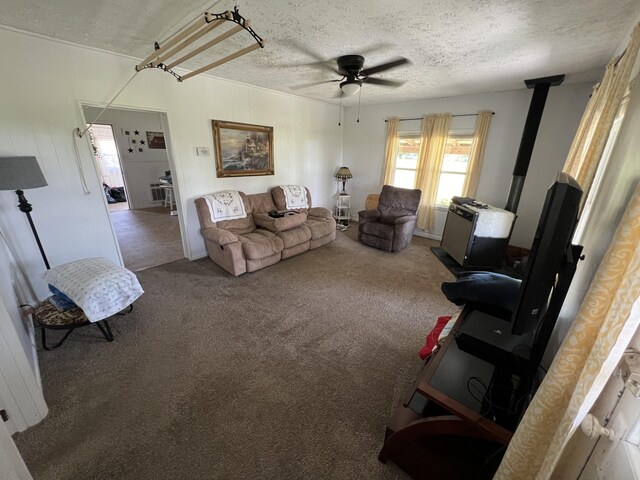 carpeted living room featuring a textured ceiling and ceiling fan