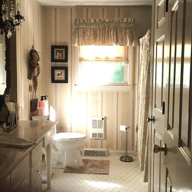 bathroom featuring vanity, a shower with shower curtain, tile patterned flooring, toilet, and heating unit