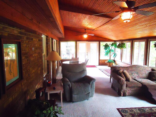 carpeted living room with lofted ceiling, ceiling fan, brick wall, and wooden ceiling