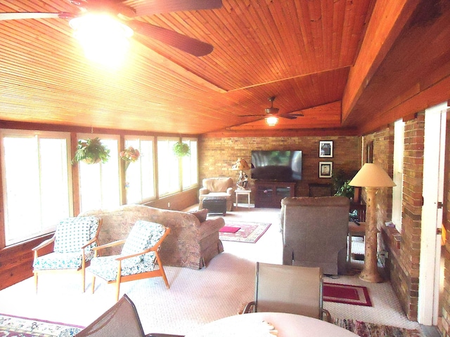 carpeted living room featuring wooden ceiling, a healthy amount of sunlight, brick wall, and ceiling fan