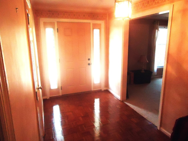 foyer with dark parquet flooring