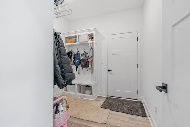 mudroom featuring wood finished floors and baseboards