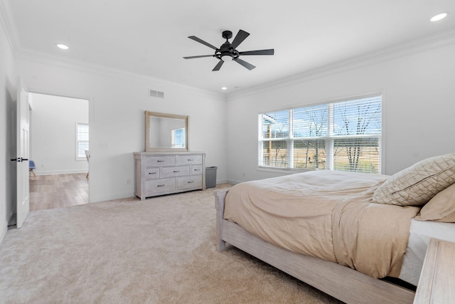 carpeted bedroom with visible vents, ornamental molding, baseboards, and recessed lighting