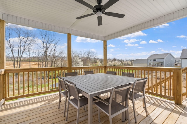 wooden terrace with ceiling fan and outdoor dining space