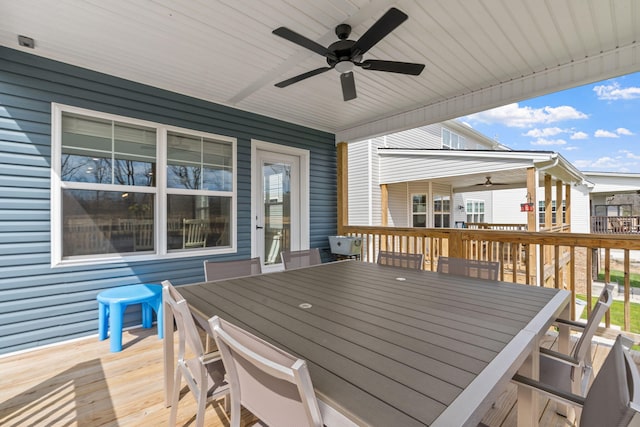 wooden deck with ceiling fan and outdoor dining space