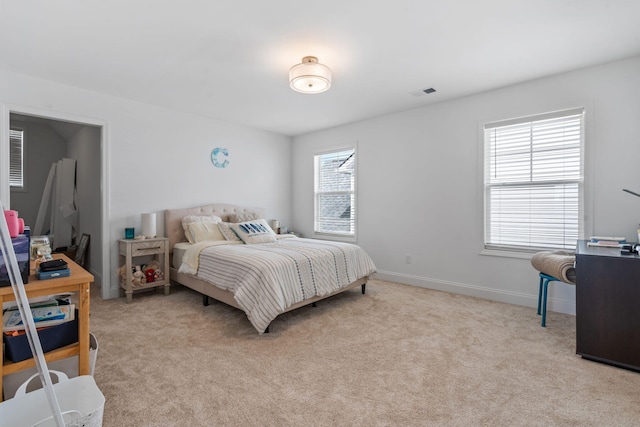 bedroom featuring light colored carpet, visible vents, and baseboards