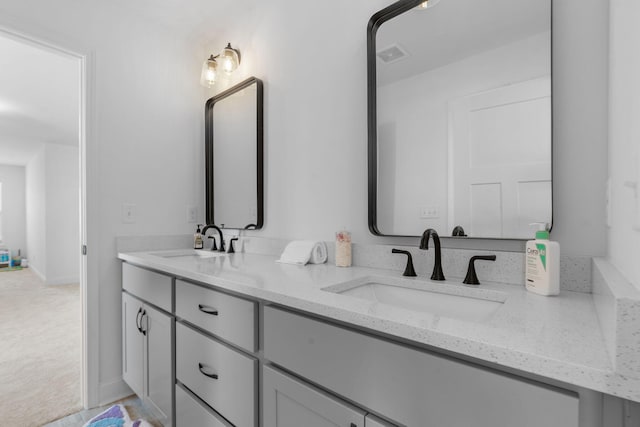 full bath featuring visible vents, a sink, and double vanity