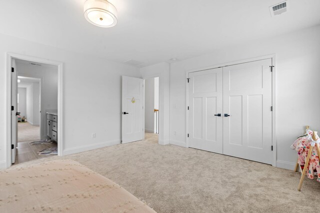 unfurnished bedroom with carpet floors, baseboards, and visible vents