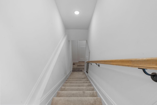 stairway featuring baseboards, carpet flooring, and recessed lighting