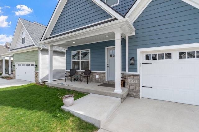 view of front facade featuring an attached garage, covered porch, stone siding, driveway, and a front lawn