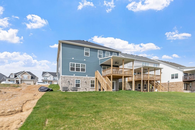 back of property with a yard, a ceiling fan, central AC, a wooden deck, and stairs