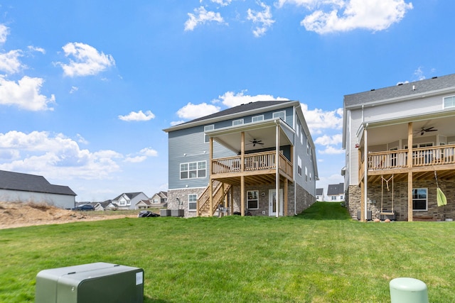 rear view of property with a yard, central air condition unit, stairway, ceiling fan, and a wooden deck