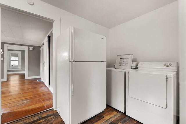 washroom featuring dark hardwood / wood-style flooring and washing machine and clothes dryer