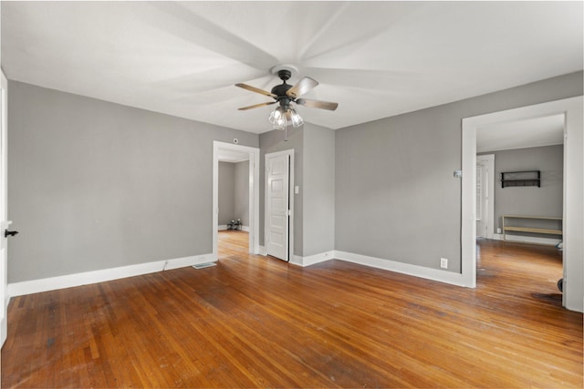 empty room with ceiling fan and hardwood / wood-style floors