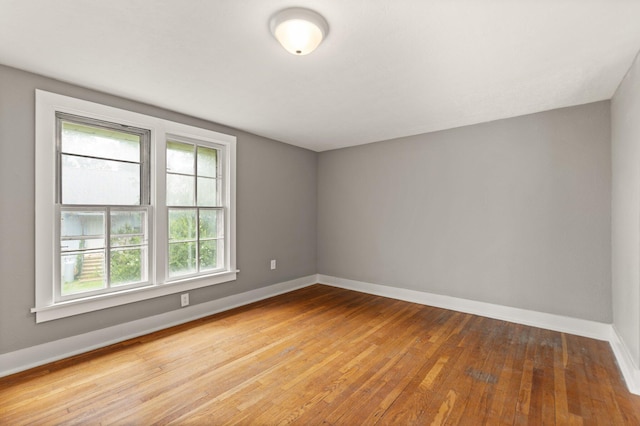 empty room with light hardwood / wood-style flooring