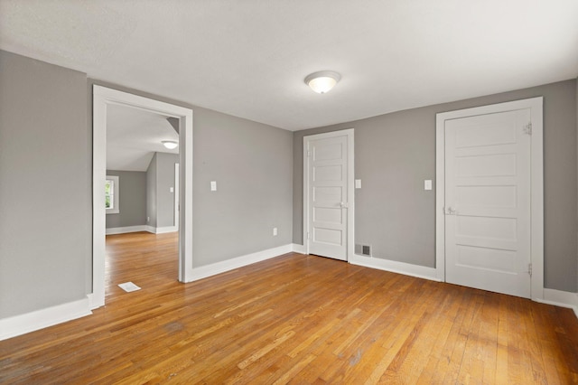 empty room featuring wood-type flooring