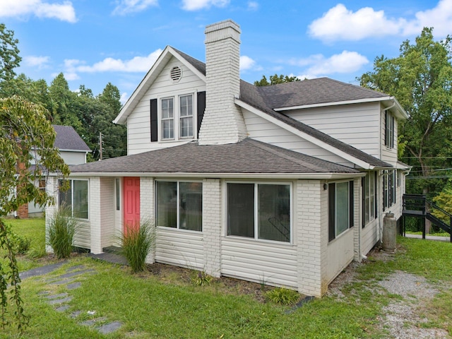 rear view of house with a lawn