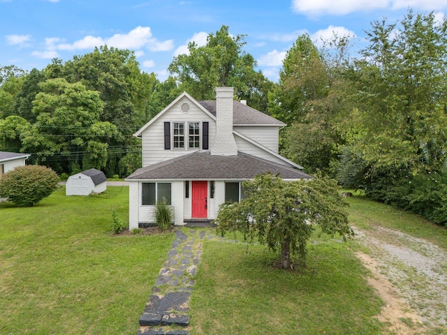 view of front of property with an outbuilding and a front yard