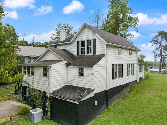 exterior space with a yard and central AC unit