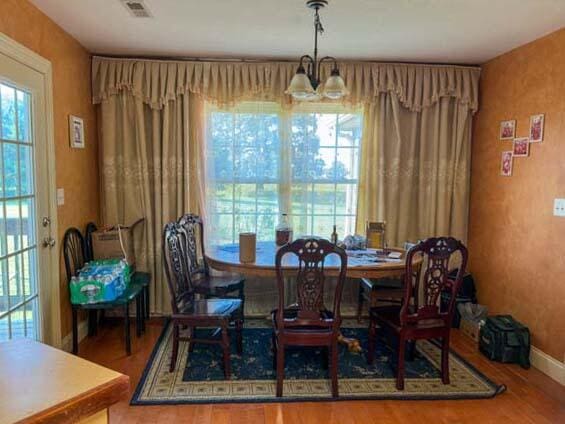 dining space with a notable chandelier and hardwood / wood-style flooring