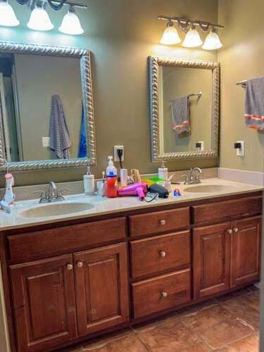 bathroom with double vanity and tile patterned floors