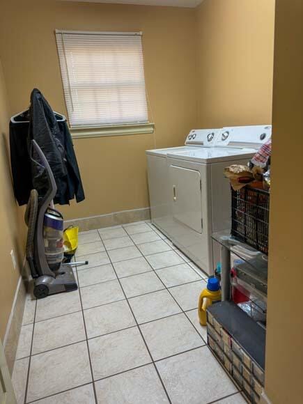 laundry room with light tile patterned floors and separate washer and dryer