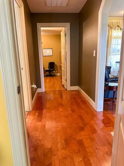 hall with hardwood / wood-style flooring