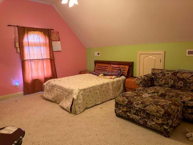 carpeted bedroom featuring lofted ceiling