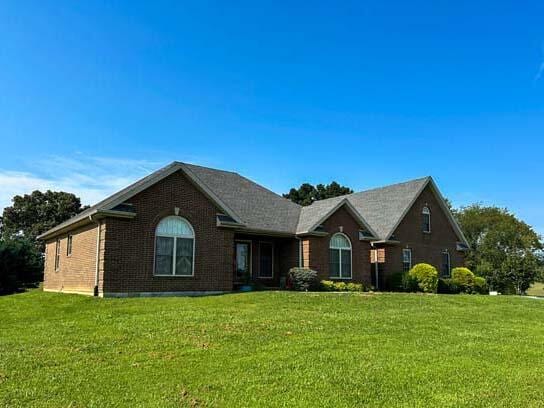 ranch-style home with a front lawn