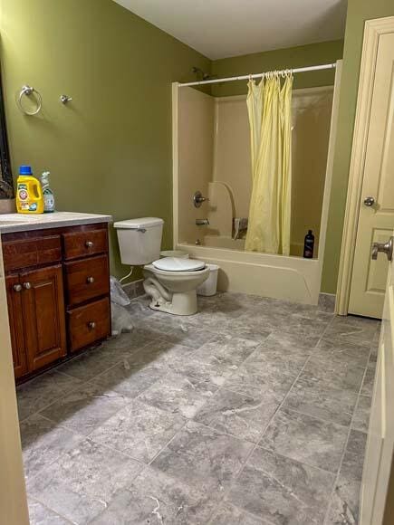 full bathroom featuring tile patterned flooring, vanity, toilet, and shower / bath combo