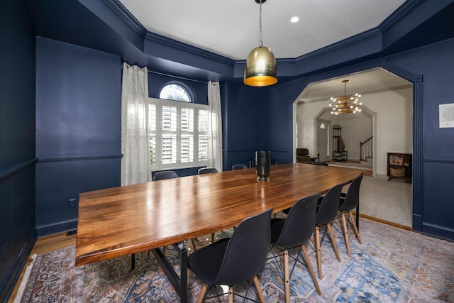 dining room featuring baseboards, stairs, arched walkways, and ornamental molding