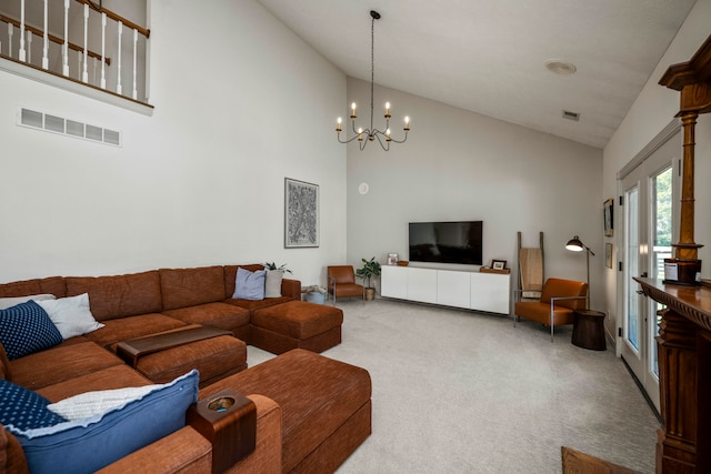 living room with high vaulted ceiling, a notable chandelier, and carpet flooring